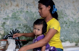 women working with child on lap